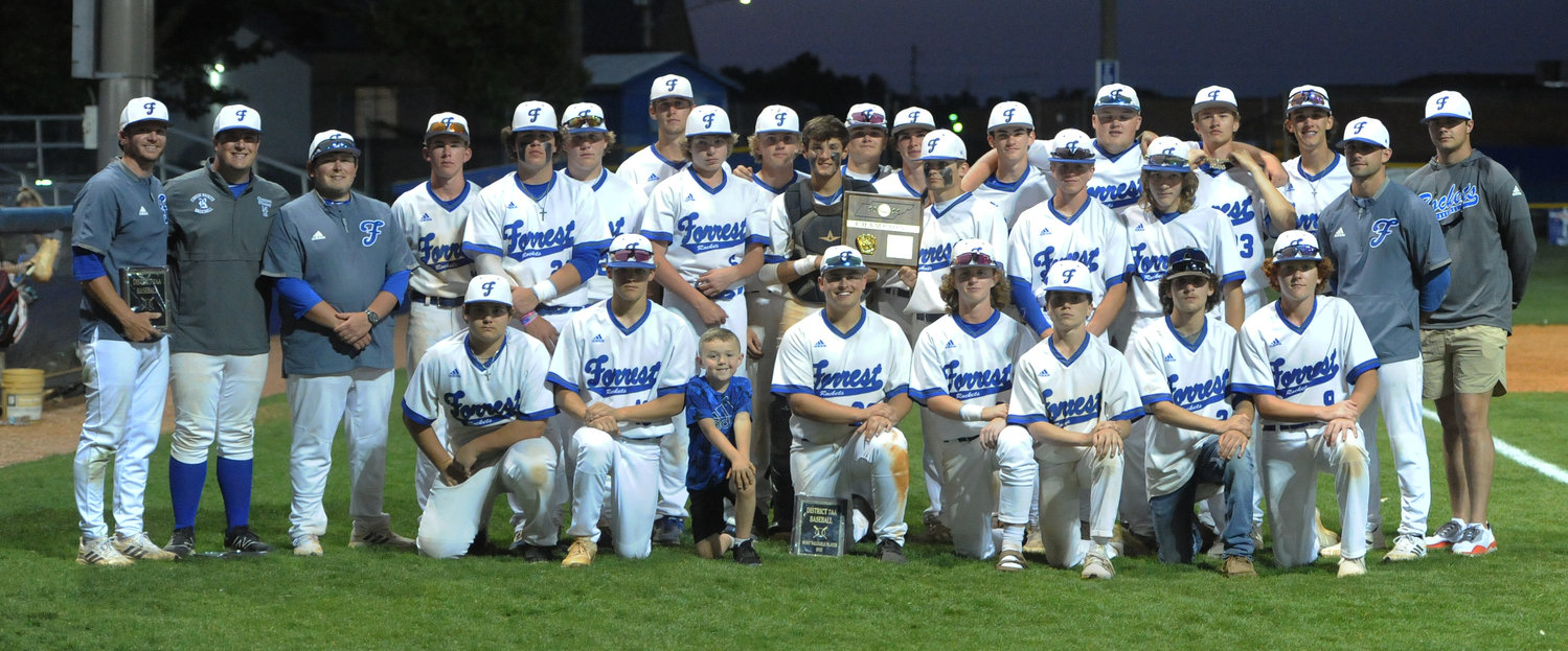 The Forrest Rockets pose with their newly acquired hardware after defeating Community in the district finals on Tuesday.