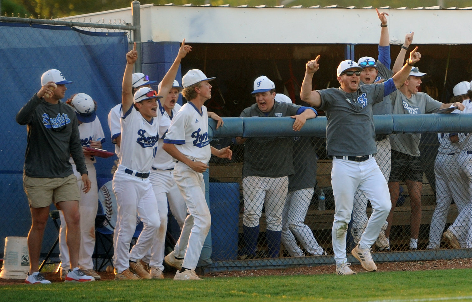 The Rocket dugout erupts after recording the final out and securing the district championship.