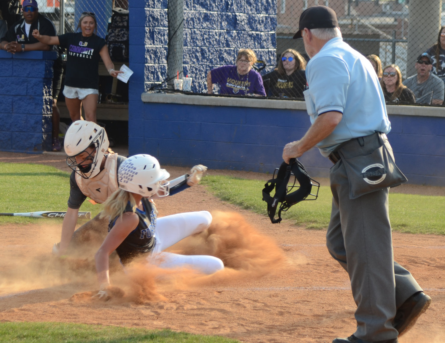 Macyn Kirby slides home in a cloud of dust to give Forrest a 1-0 lead.