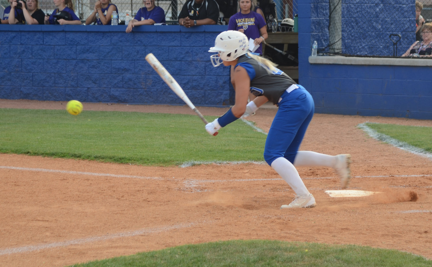 Abby Ferguson lays down a sacrifice bunt that was misplayed by the Viqueens, leading to a run in the first inning.