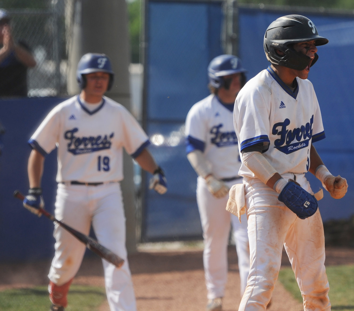 Senior Cam Vaughn (5) lets out a roar of emotion after scoring the game-tying, ninth run in the bottom of the seventh inning on Friday.