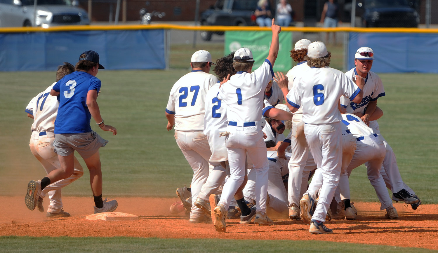The Rockets dogpile on Preston Gentry, who singled home the game-winning run in the bottom of the eighth inning.