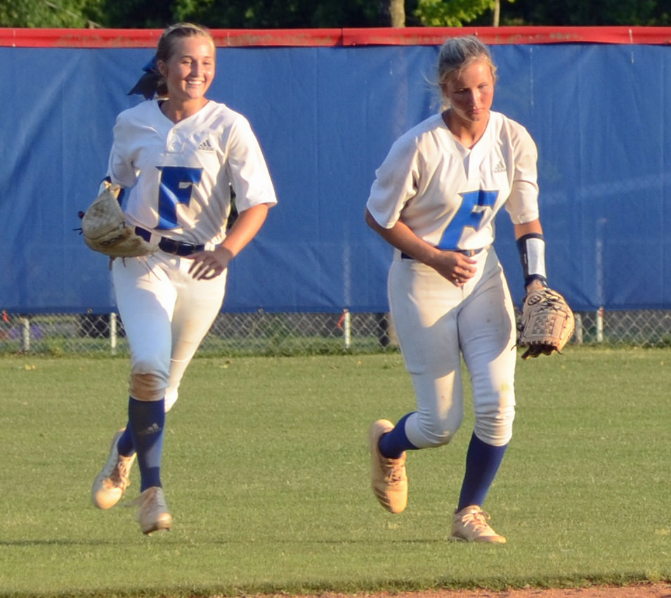 Maggie Daughrity and Briley Burnham are all smiles after Burnham made the catch for the final out in the state sectional game.