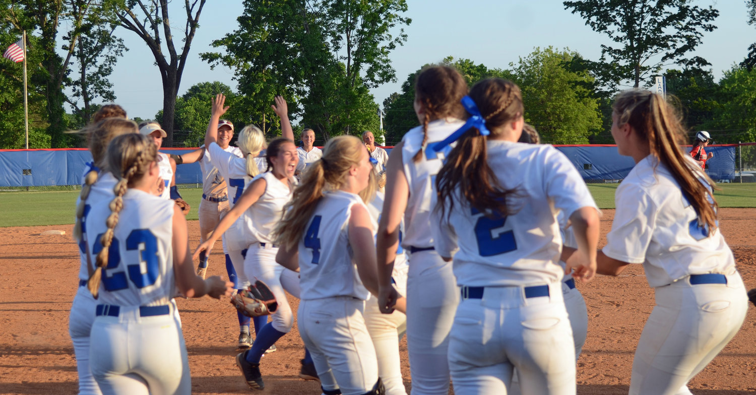 The Lady Rockets rush the field to celebrate after the final out.