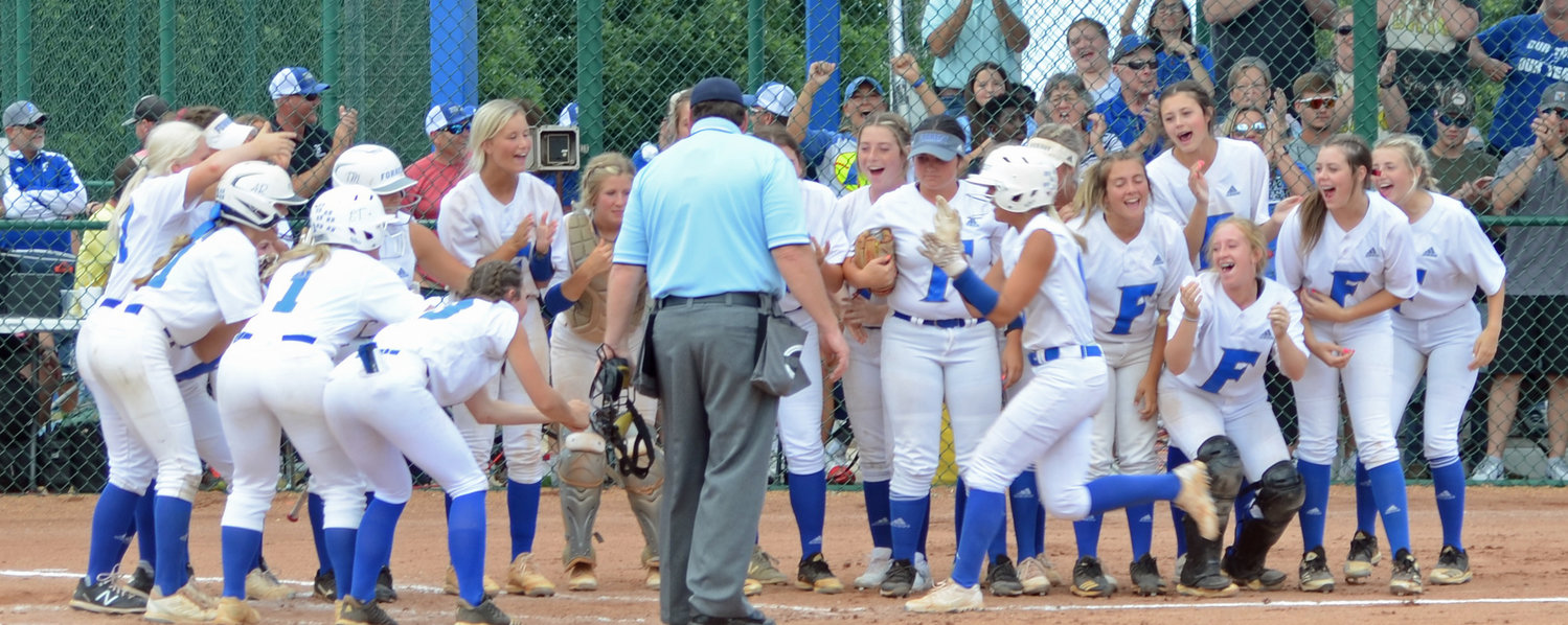 Abby Ferguson gets ready to touch home plate and get mobbed by her teammates after slamming a two-run homerun in the third inning.