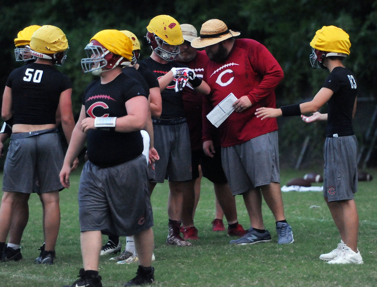 Bulldog head coach Shelby Waddell huddles up with the offense during a drill at a recent practice.