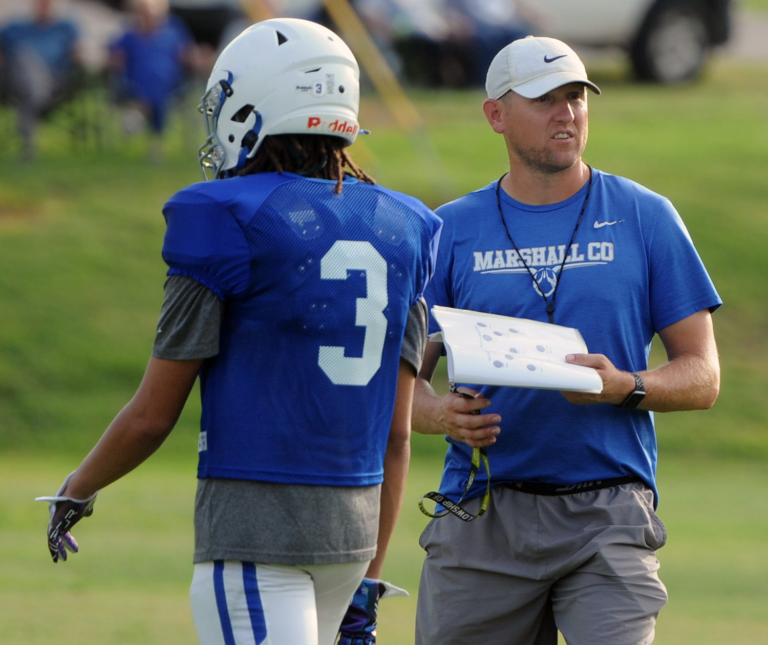 Coach Thomas Osteen gets the offense organized for the first Marshall County possession in the scrimmage.