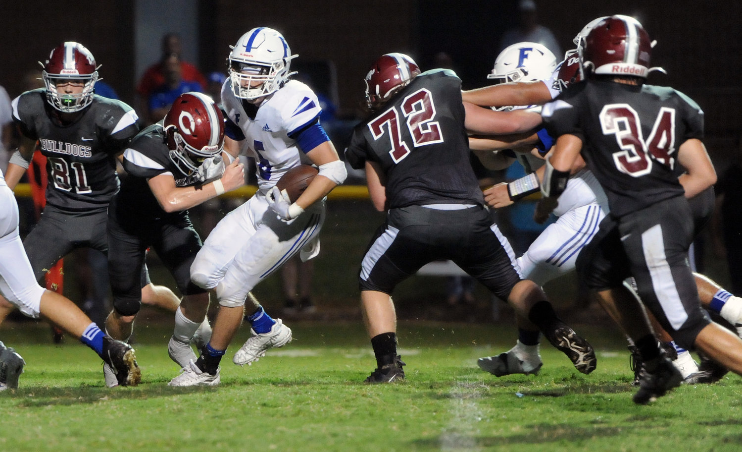 A host of Bulldogs converge to bring down Rocket quarterback Ryan Hill on a keeper.
