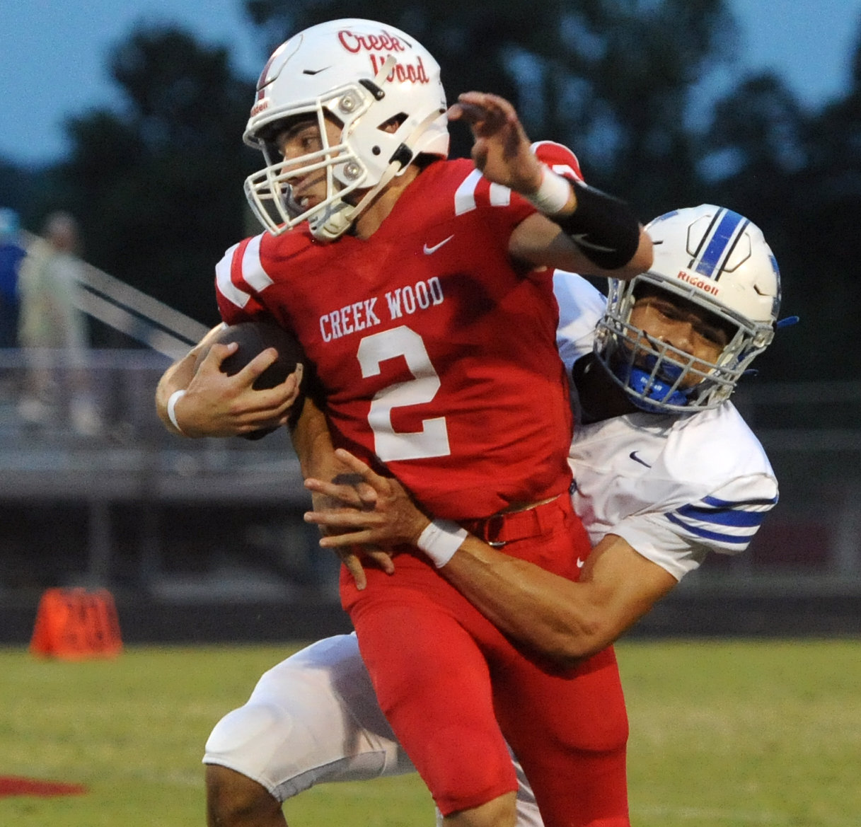 Darien Crenshaw wraps up Red Hawk quarterback Eathon Donaldson for a tackle for loss against Creek Wood on Friday.
