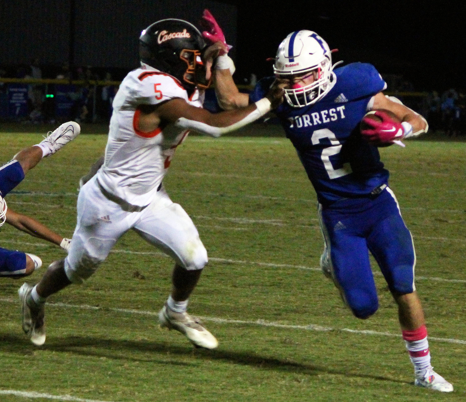 Tayton Swift gives a stiff arm and picks up a handful of yards for Forrest.
