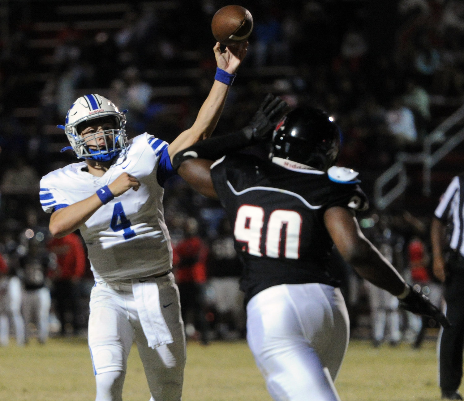 Tiger quarterback Silas Teat fires a throw despite heavy pressure by the Pearl Cohn defense. He had one touchdown pass to Aja Jones on Thursday night.