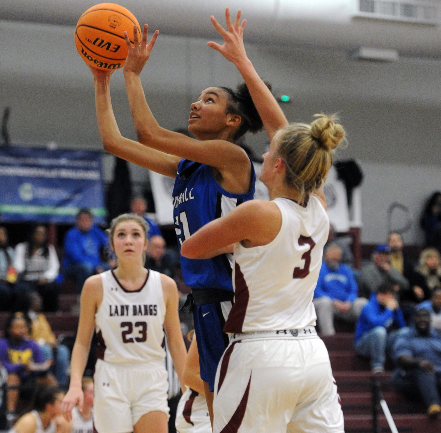 Mashawna Ridley draws heavy contact as she fights her way to the rim.