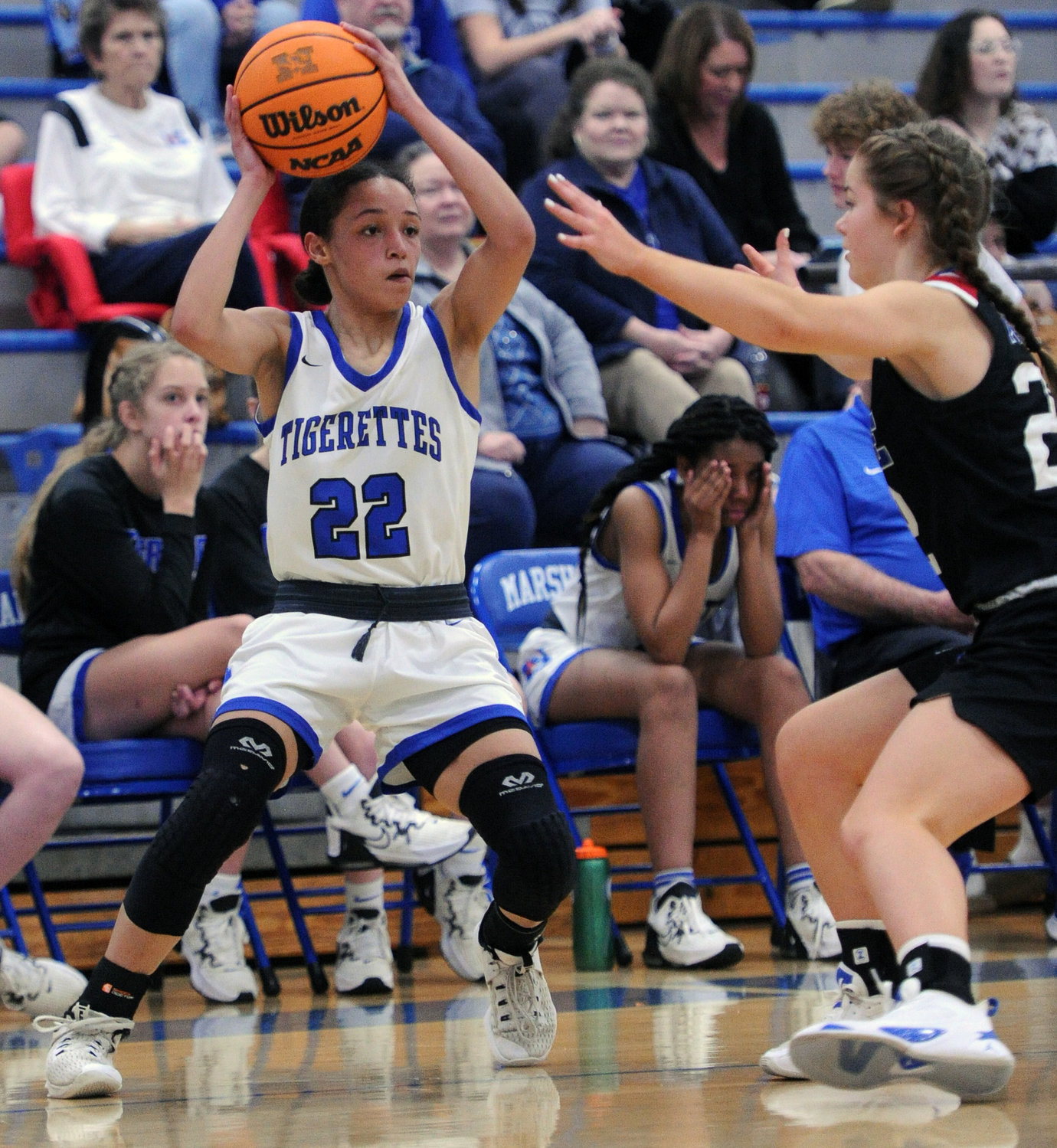 Kayla Keiler surveys the floor from the corner and looks to pass the ball. She led the Tigerettes with 14 points.