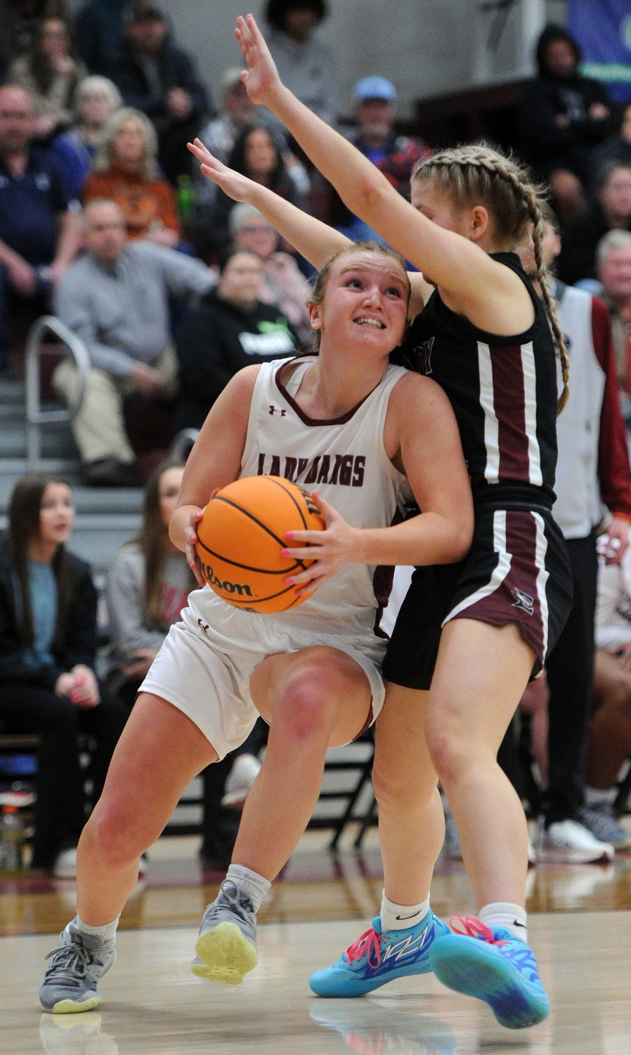 Anna Wood draws a foul as she battles her way along the baseline and puts up a shot.