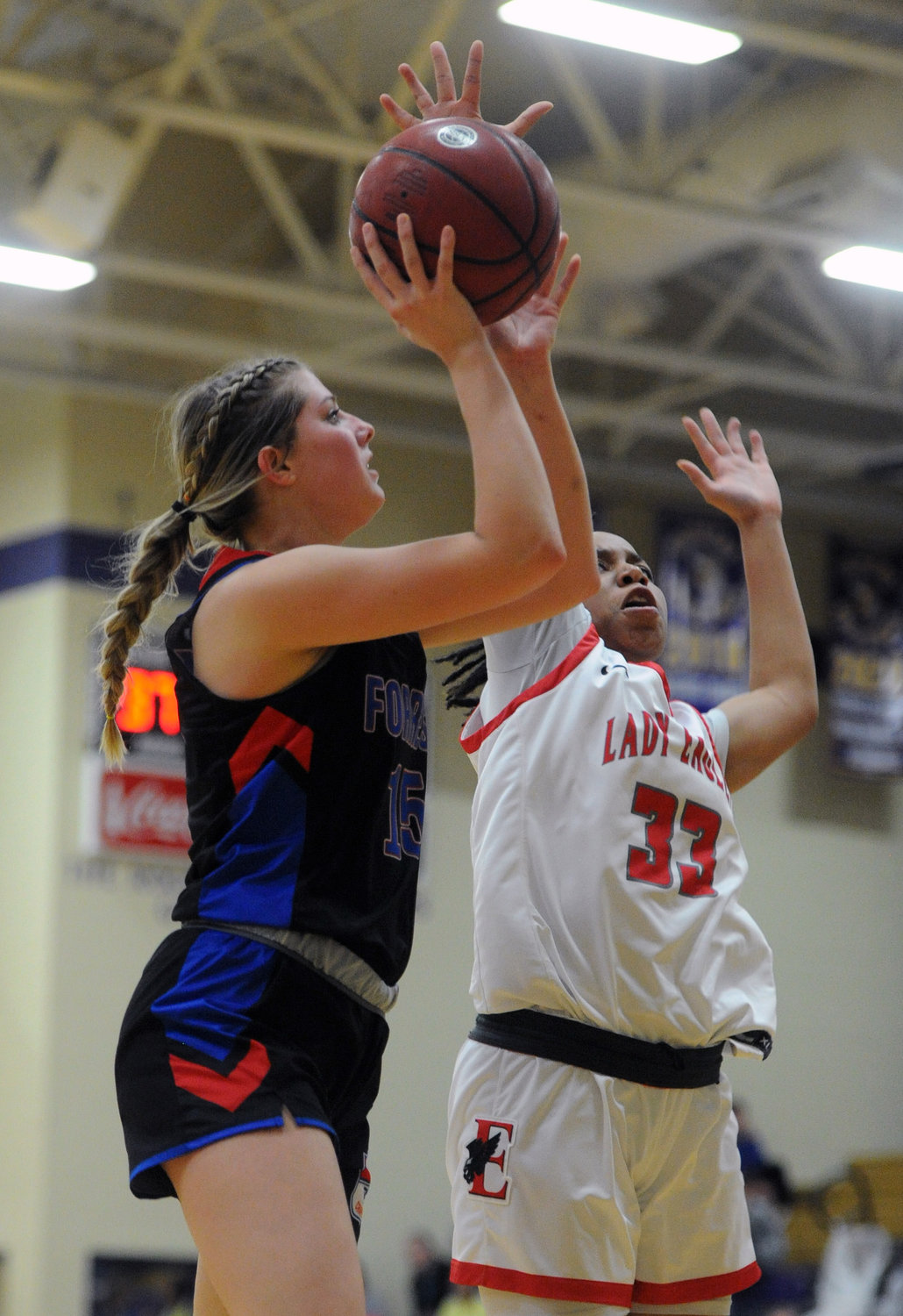 Senior Megan Mealer goes up for two and draws contact from the East Nashville defense.