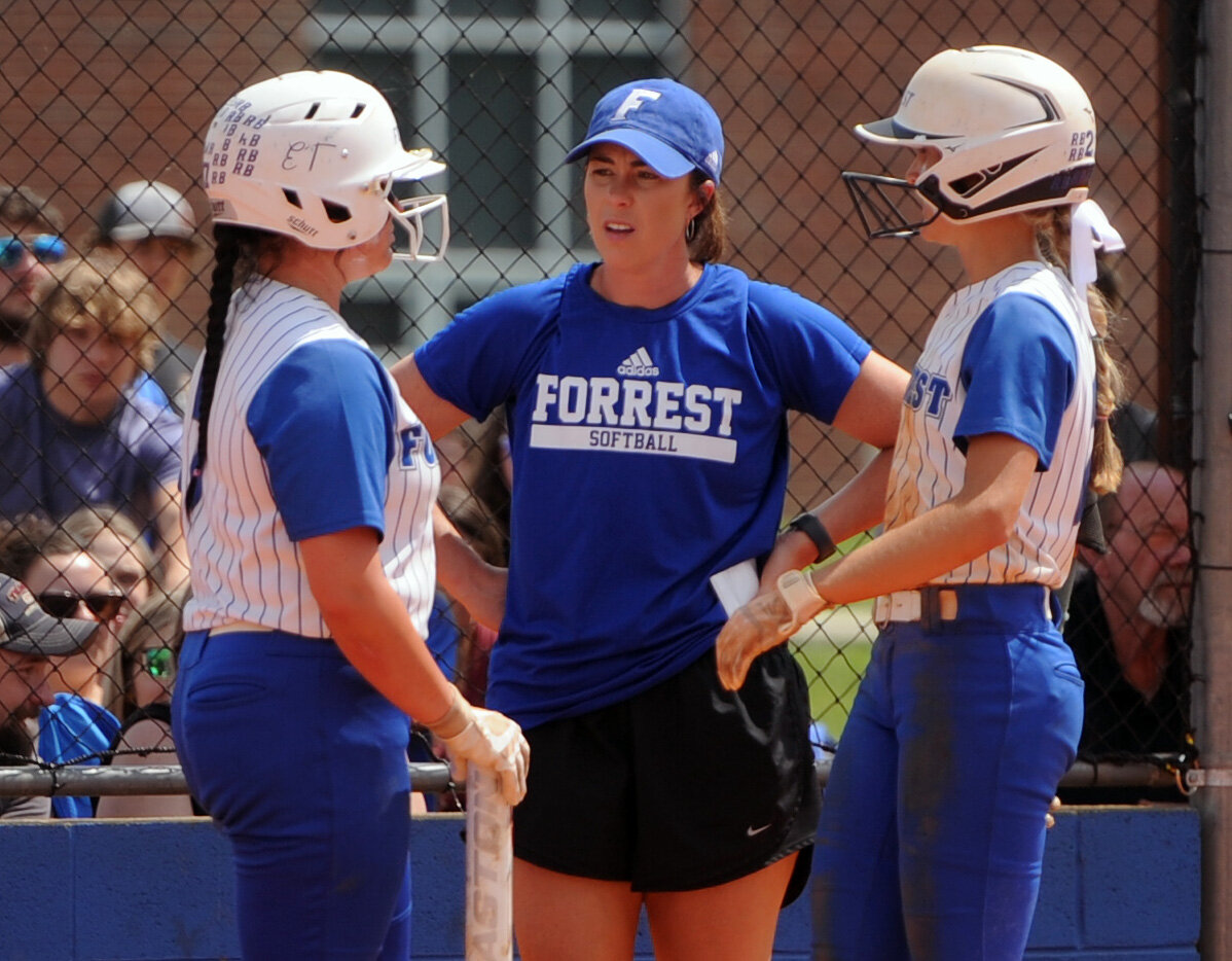 Carli Warner (left) and Maggie Daughrity chat with coach Shelby Lightfoot during a break in the action on Friday afternoon.