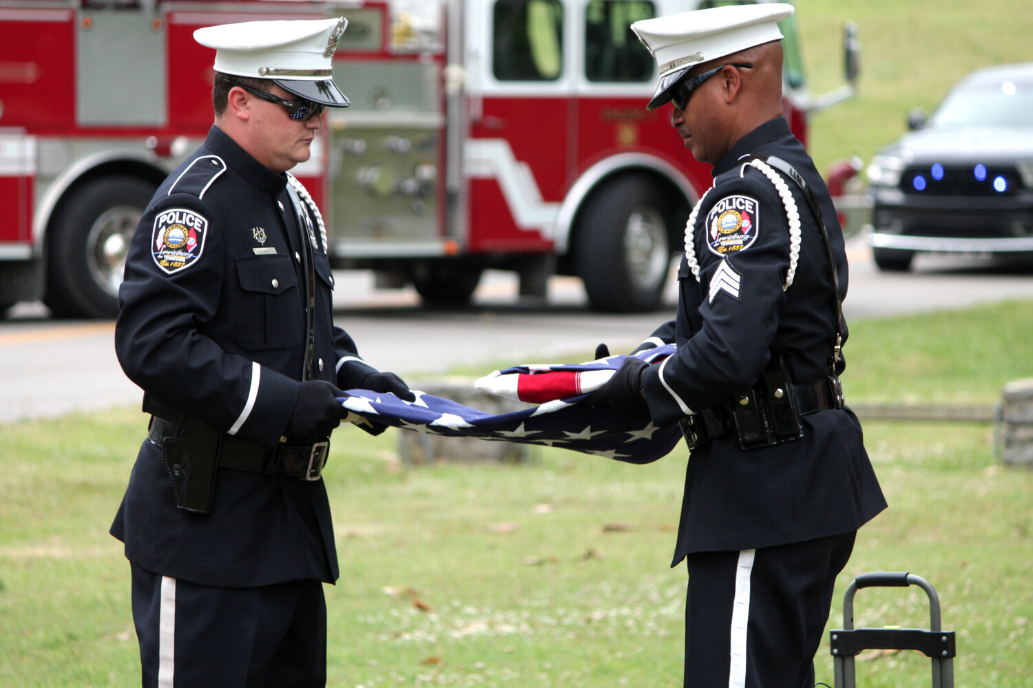 Detective Santiago McKlean (right) and Officer Dustin Turner (left) of the Lewisburg Police Color Guard as they present the colors for the ceremony. 