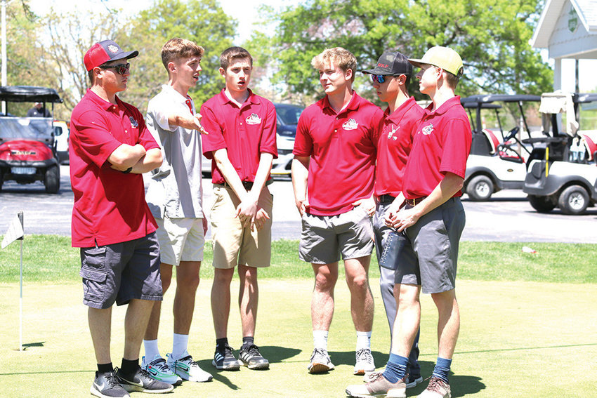 Grant Qualls makes a point to his Mexico golf teammates as they await the outcome of a playoff between Hannibal's Quinn Thomas and Hunter Parker. With Qualls are Tyler Scheiner, Aiden Knipfel, Haden Hatfield, Landon Love and Geoffrey Penn. [Dave Faries]