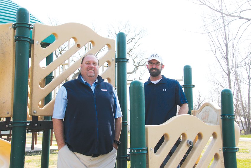 Jon Lindell of Cunningham Recreation and Laddonia mayor Josh Deimeke stand on the one piece of playground equipment that will remain after the city begins installing new features next month. Laddonia had been saving money for the project for six years. [Dave Faries]