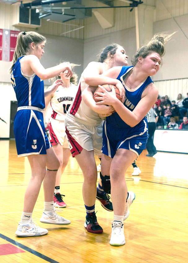 Trojans' forward Alexis Welch fights for the rebound against Jamestown's Madalynn Sedgwick. [Leslie A. Meyer Photography]