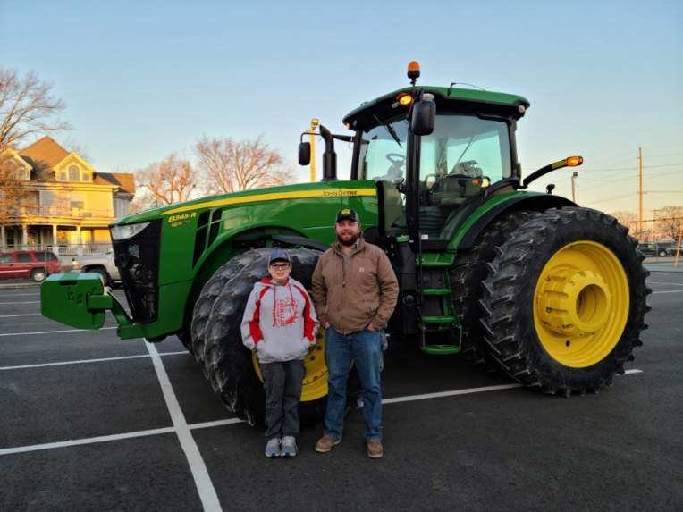 Drew Feger got a memorable ride to school Feb. 5. He is joined by tractor driver Connor Templeton, Sydenstricker employee. [Submitted Photo]