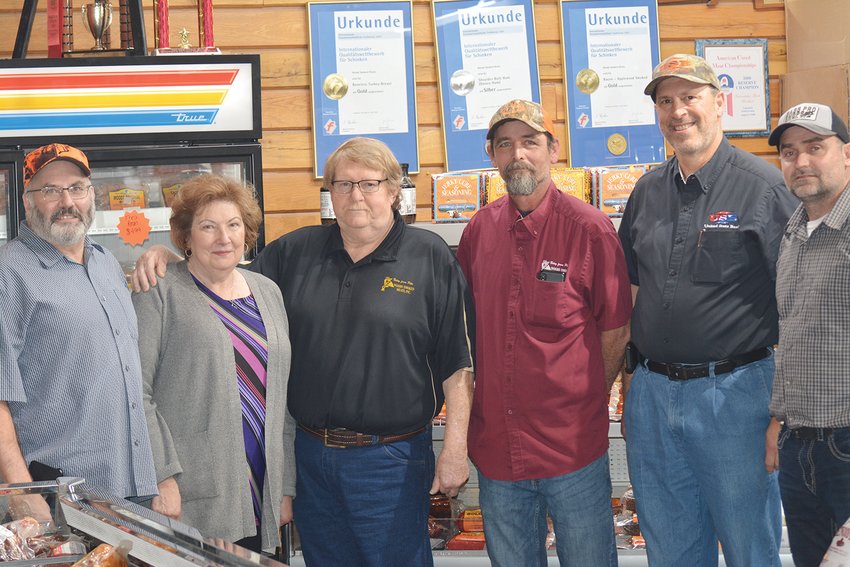 Woods Smoked Meats, Bowling Green, recently sold to HWC Meats. Those present for the closing, from left, are Mike Sloan, Hermann Wurst Haus; Ed and Regina Wood, Woods Smoked Meats; Steve Bolton, Woods Smoked Meats general manager; Randy Trenhaile, United State Bank; and Cory Hawkins, Central Missouri Meat &amp; Sausage. Trenhaile is senior vice president of United State Bank and was the one who arranged the financing for the purchase of Woods Smoked Meats. [Submitted photo]