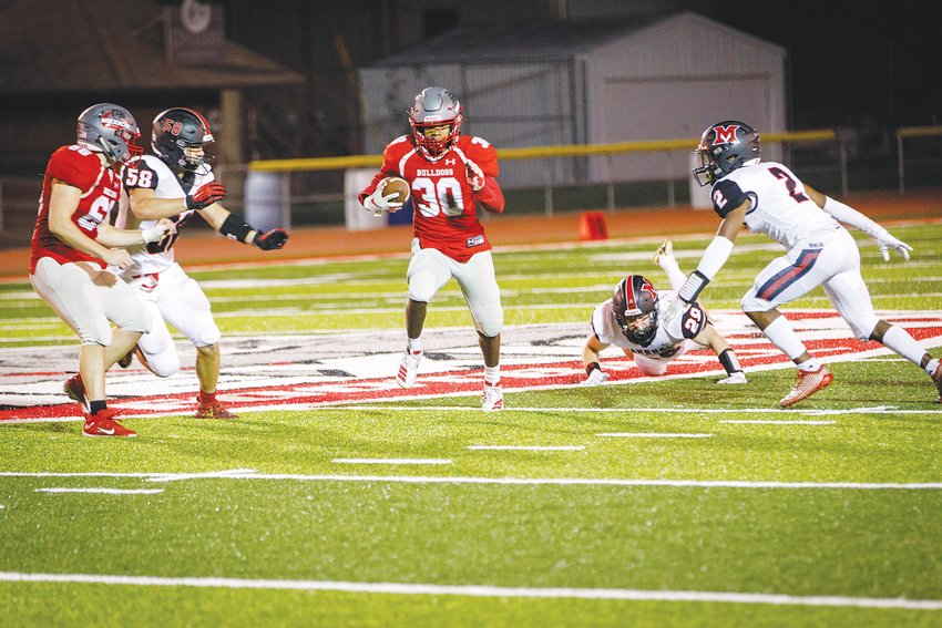 Mexico running back Anthony Shivers finds plenty of space to roam during a big gain in Friday&rsquo;s 28-20 triumph over Marshall. Shivers had a 40-yard touchdown reception in the win. The Bulldogs (2-1) play at Hannibal (3-0) this Friday. [PHOTO COURTESY OF DAVID PICKERING PHOTOGRAPHY]