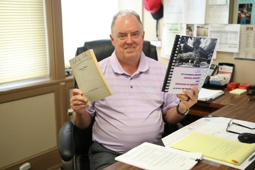 Deputy city manager Roger Haynes shows off a 1950-51 city budget alongside Mexico&rsquo;s current volume. [Dave Faries]