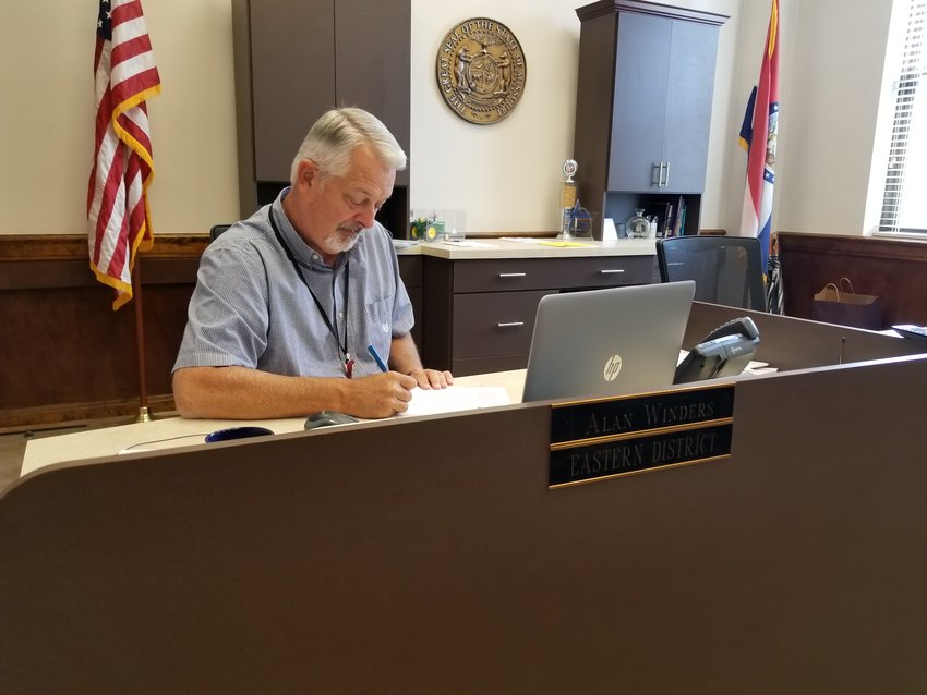Alan Winders still occupies his old desk in the County Commissioner&rsquo;s office despite being named presiding commissioner. Winders entered government work right out of college. [Dave Faries]