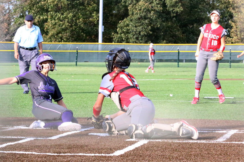 Mexico catcher Karlee Sefrit tags out Avery Oetting at home in the bottom of the first inning Wednesday. Kierstan Epperson is in the background. [Nathan Lilley]