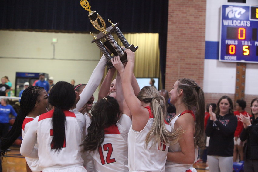 The Mexico girls basketball team hoists the Montgomery County Invitational championship trophy after beating Montgomery County 45-36 in the finals on Dec. 4. It&rsquo;s the Bulldogs&rsquo; 12th championship, a tournament record. THEO TATE PHOTO