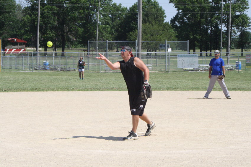 Dustin Null, of the Mexico Optimist Club, lobs a pitch toward home plate Monday at the Mexico Optimist Ball Fields during a mushball game. The tournament serves as a fundraiser for the organization.