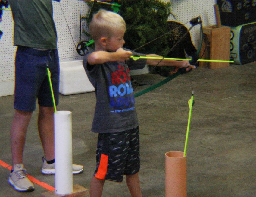 Children, in grades third to fifth, try archery July 13 at Reading Farms USA for the Mexico Area Family YMCA outdoors camp. The YMCA has held sports camps for children in grades kindergarten through fifth.