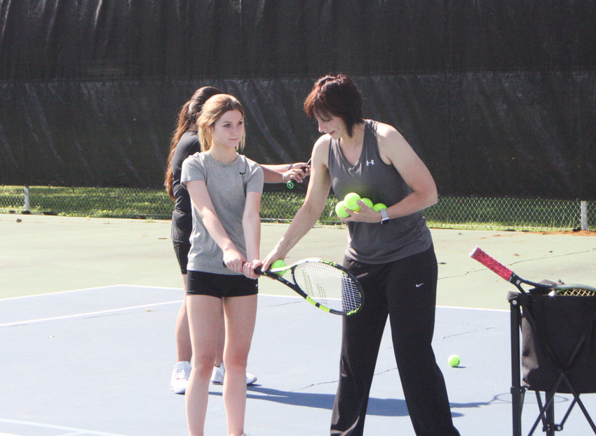 Mexico girls tennis head coach Kim Costley works with freshman Kayden Higbee on July 11 during a camp at Fairgrounds Park in Mexico.