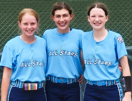 From left, Centralia middle schoolers Karli Andersen, Jaylynn Brown and Ealynne Bostick are together before a game in the Central regional round of the softball Little League World Series in Whitestown, Indiana.