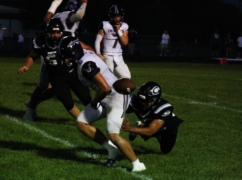 Hallsville's Gauge Harbison has the ball ripped from his arm Friday in Centralia's 26-20 win at home against its district foe. The Panthers' defense came away with four turnovers it used to erase an early 12-0 deficit.