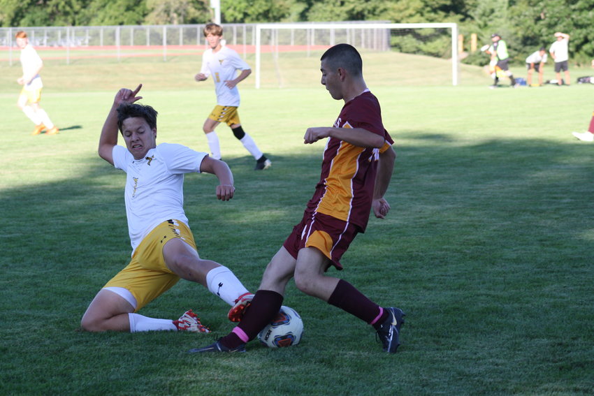 Missouri Military Academy senior midfielder Guillermo Banuelos sustains a tackle by Fulton's Dalton Jones on Thursday in the Colonels' 5-2 loss.
