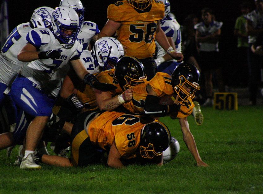 Van-Far junior quarterback Nikos Connaway is piled up with his teammates and some Wildcats on Friday during the Indians' 14-12 victory against Montgomery County on their new home field in Vandalia. Connaway ran for two touchdowns to help Van-Far snap a 15-game losing streak.