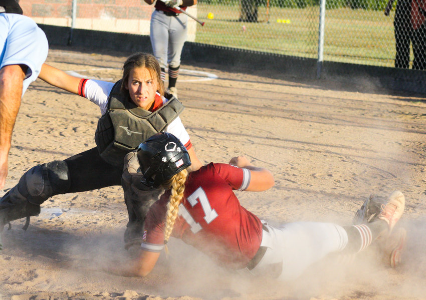 Community R-6 junior catcher Brooklynn Glasgow tags out a Louisiana runner trying to score after receiving senior center fielder Kayla Jett's throw Tuesday in the Lady Trojans' 7-5 win in Laddonia. Glasgow also hit the game-winning three-RBI home run.