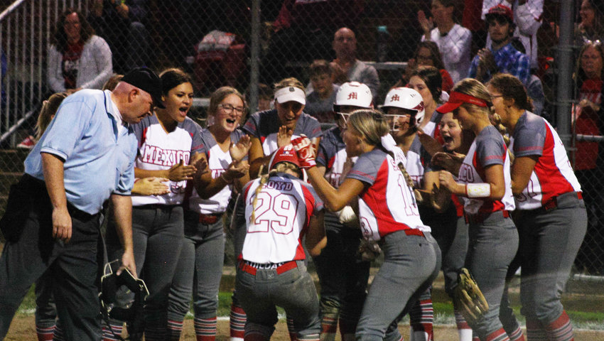 Mexico freshman catcher Hannah Loyd is mobbed at home plate Thursday by her teammates after hitting her second home run, tallying two of her seven RBI against Fulton.