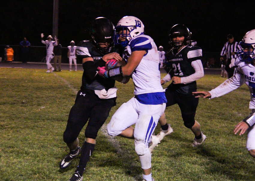 North Callaway senior Braydn O'Neal senior defensive back tries to rip the ball away from Montgomery County's Travis Hill on Friday during the Thunderbirds' 42-38 win at home.