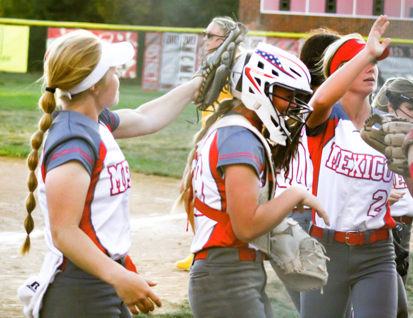Mexico senior Abby Bellamy (left) shares a moment with freshman Hannah Loyd (middle) and junior Jo Thurman in a game against Fulton this season. The trio were named to the all-North Central Missouri Conference and all-district team. Senior pitcher Eboni Mayfield joined them on the all-district team, and several more area softball players with North Callaway, Community R-6 and Van-Far were recognized for their respective seasons.