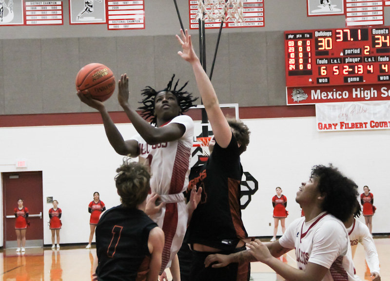 Mexico junior DJ Long goes for a contested layup Tuesday at home against Kirksville. Long finished with 26 points in the loss to go along with senior Jordan Shelton's 26 points. The Bulldog duo was the counter to Kirksville's Isaac Danielson and Keaton Anderson, who each finished with 32 points.