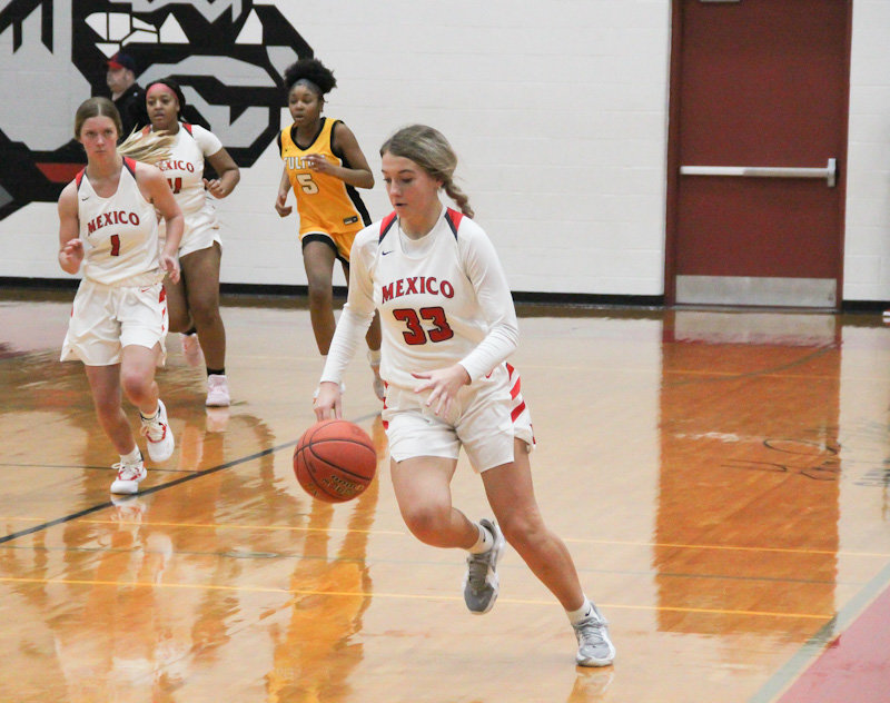 Mexico junior Karlee Sefrit steals the ball and takes it down the floor Tuesday night at home against Fulton, which the Lady Bulldogs won 41-29.