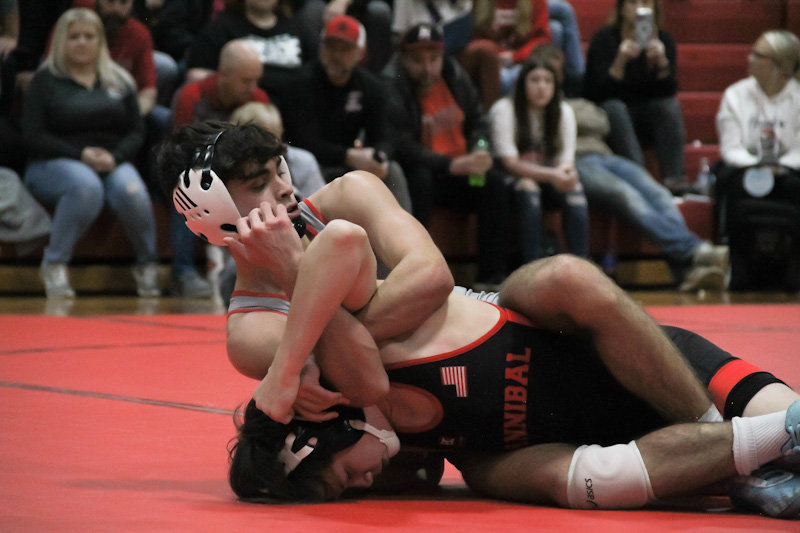 Mexico senior Gavyn Martin holds his Hannibal opponent down on Wednesday in a home dual match in Gooch gym.