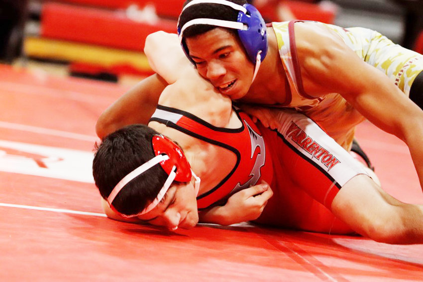 Missouri Military Academy freshman Trae Griffiths (top) gains control of his match against Warrenton's David McCauley on Saturday at the Warrenton Tournament. Griffiths pinned McCauley in the match and placed fourth in the 144-pound weight class.