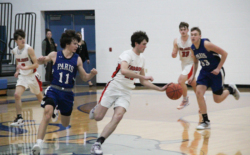 Community R-6 senior Tucker Robnett moves in transition Jan. 28 against Paris. Robnett and the Trojans had a rough game Tuesday against conference foe Cairo while the Lady Trojans also lost.