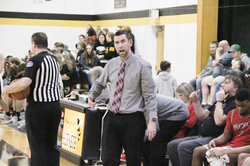 Mexico boys basketball head coach Darren Pappas shouts instructions Friday night during the Bulldogs' 81-67 victory in St. Elizabeth, which was his 100th career win as a coach.