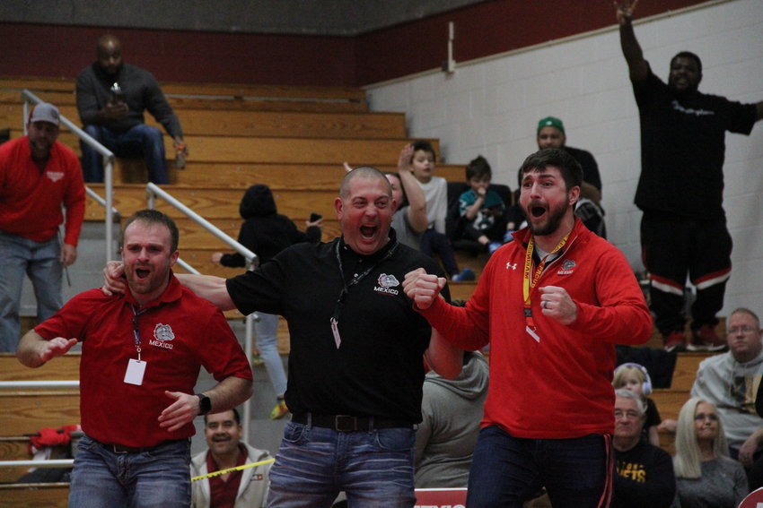 Mexico's coaching staff celebrating after sophomore Dalton Arndt pinned his opponent to qualify for state