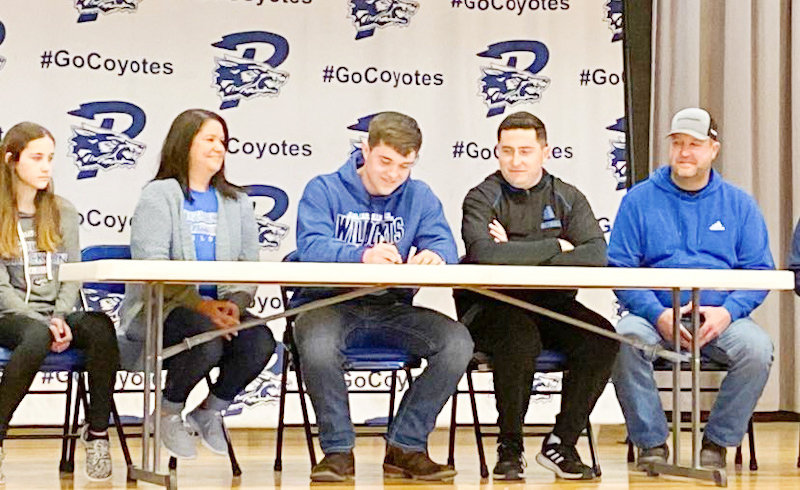 Paris senior defensive end Owen Totten is surrounded by family on Thursday in the high school gym during his college signing ceremony. The all-state defensive lineman decided to play football at the next level with NAIA school Culver-Stockton College in Canton.